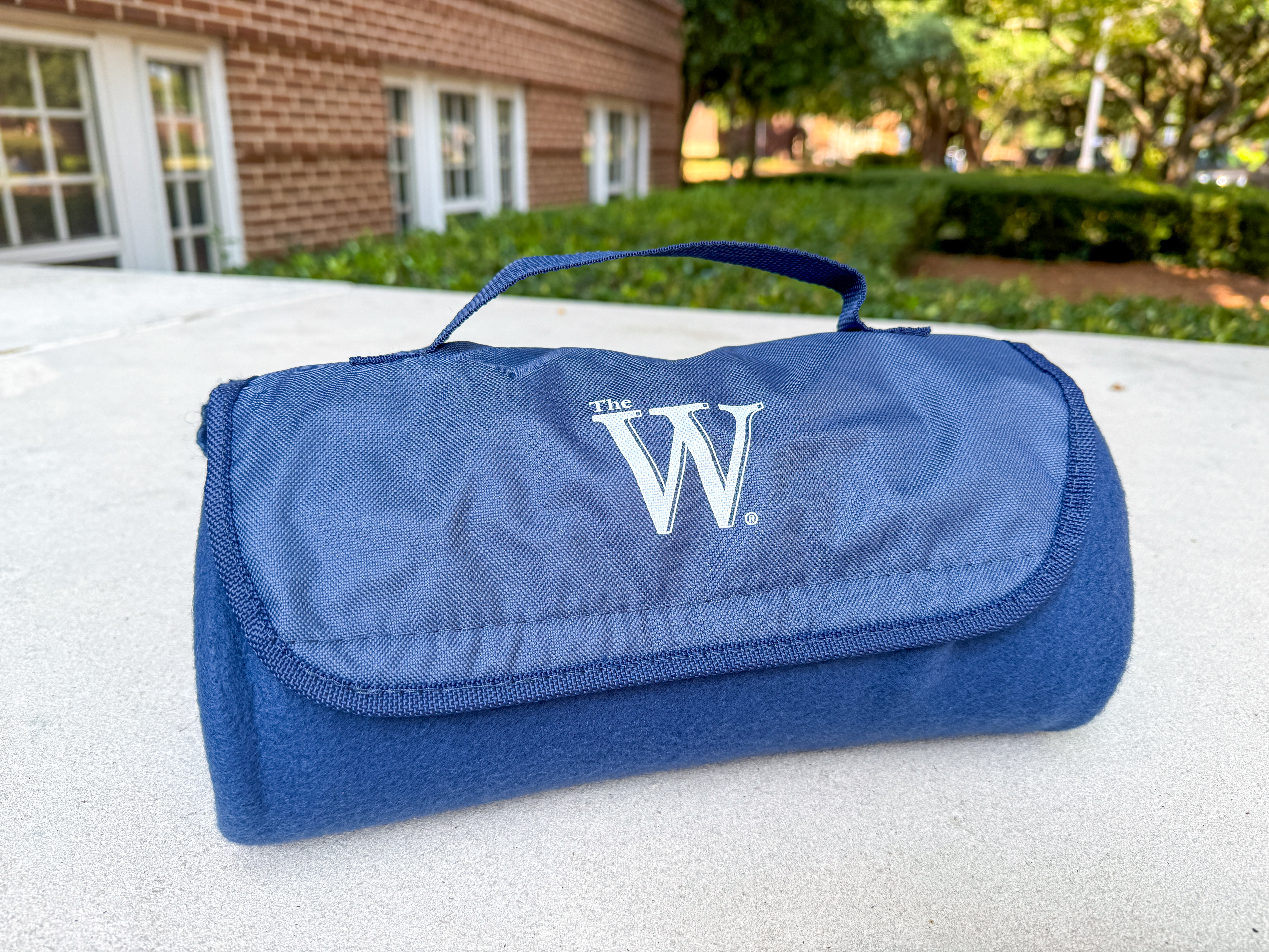 MUW blue fleece blanket with W logo