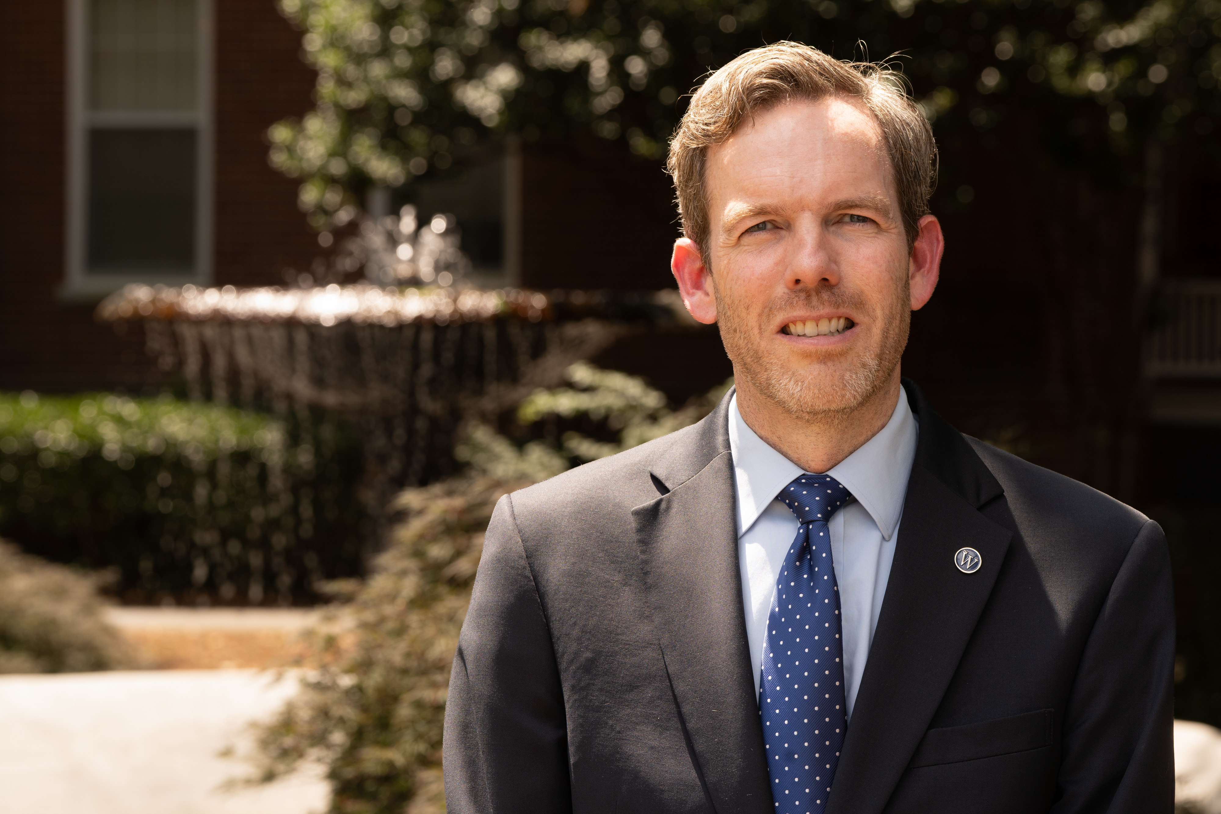 Scott Tollison standing in front of fountain on the front campus